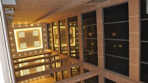 A multi-level interior with illuminated decorative panels and large windows. - Qingtian Boutique Hotel (Zhaotong Fengxia Road) (Zhaotong)