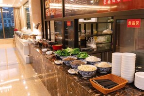 A buffet setup with various food items and dishes. - Qingtian Boutique Hotel (Wuyue Plaza Wanghai Park) (Zhaotong)