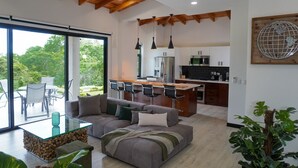 A modern kitchen with a central island, stainless steel appliances, and pendant lighting.