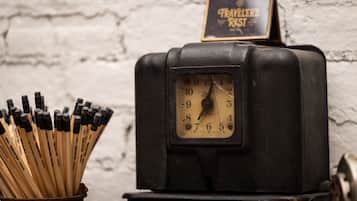 A vintage black clock with a sign above it that reads "TRAVELER'S REST".