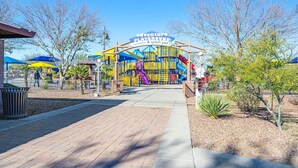 A playground with a sign reading "Adventure Playground & Splash Pad". - NEW! Cozy desert getaway with private backyard and seasonal pool! (New River)