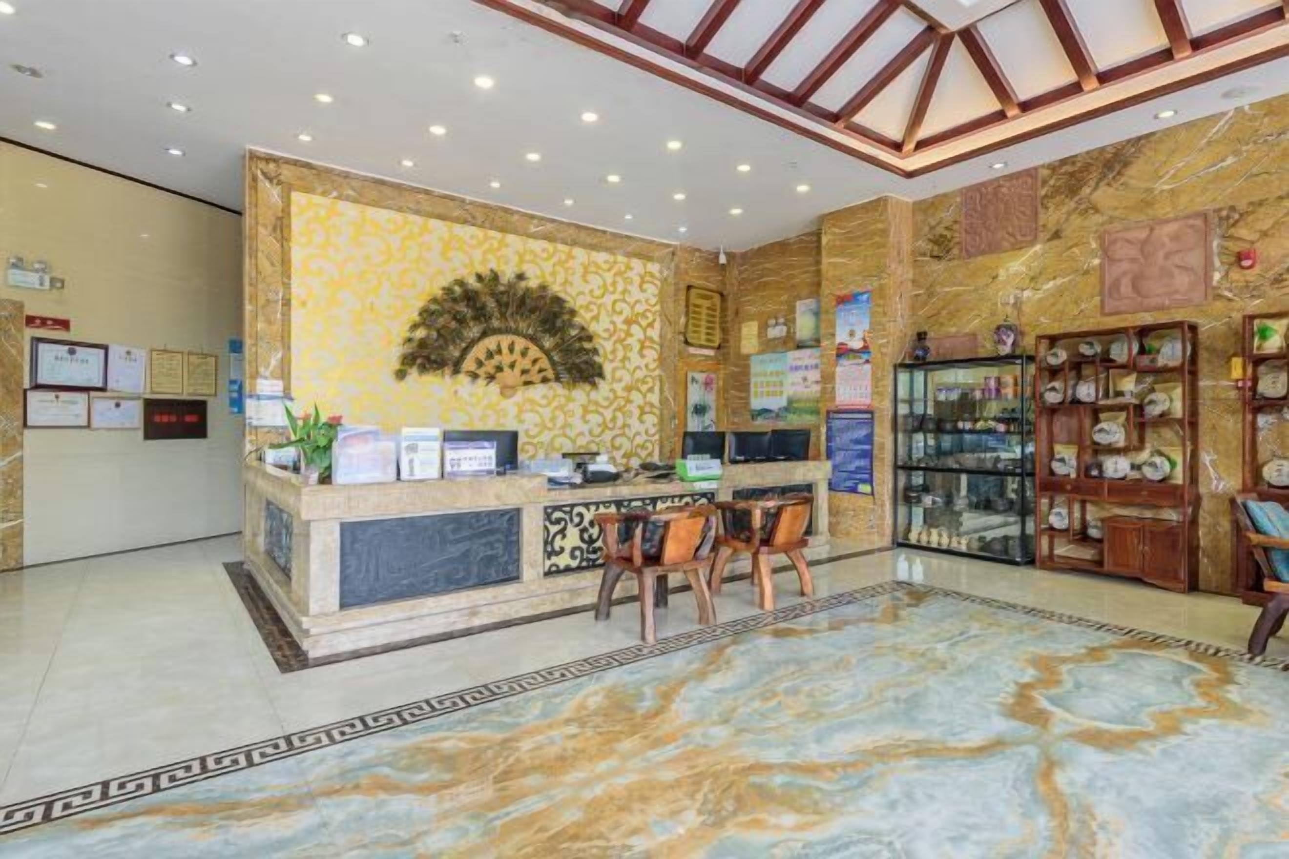 A reception area with a marble floor, a reception desk, and a display case.