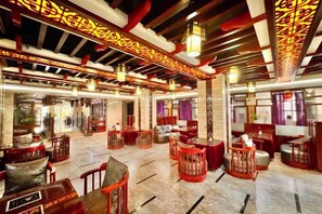 A spacious lobby with high ceilings, traditional decor, and multiple seating areas. - Yongshun Minzu Hotel (Yongshun)