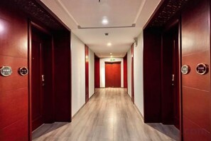 A hotel corridor with wooden doors and a wooden floor. - Yongshun Minzu Hotel (Yongshun)