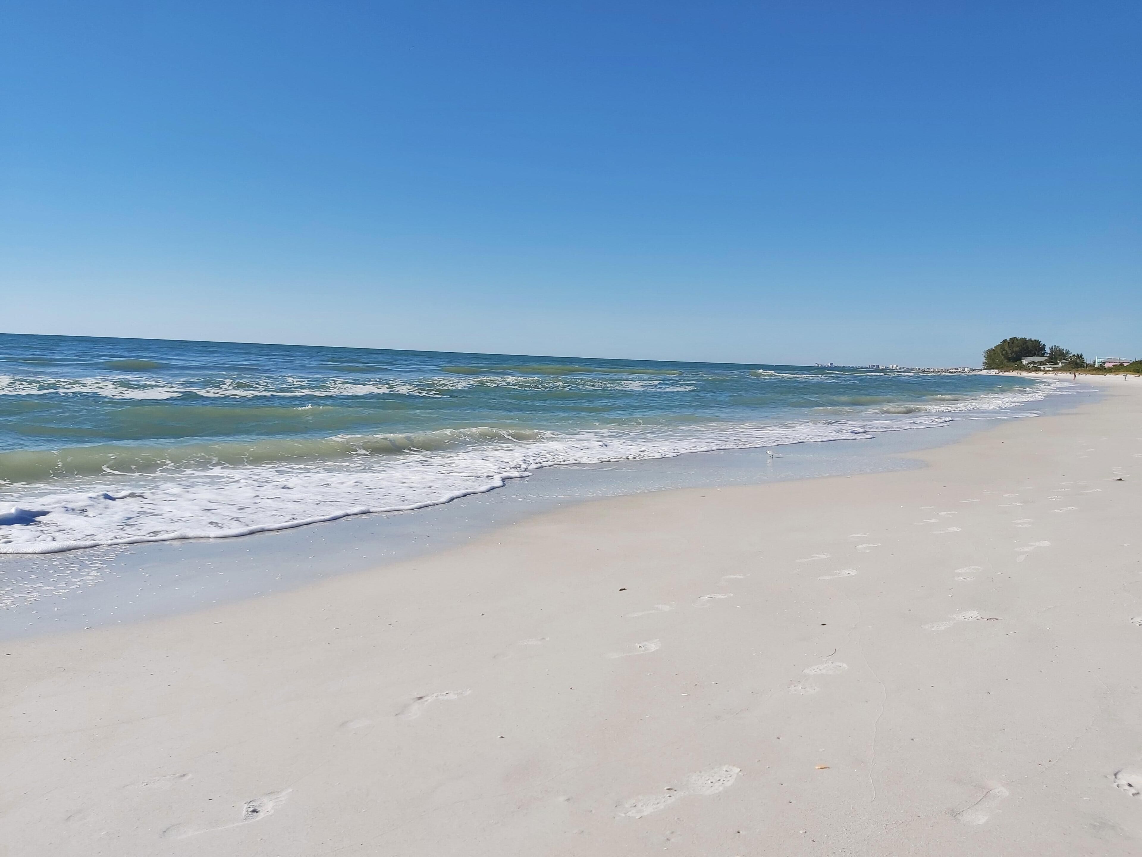 A beach with clear skies and calm waves.