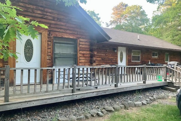 Front view with deck, table and chairs, grill.