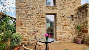A stone building with a door and a window, surrounded by plants and a small table with chairs. - Steredeg - BADEN - Gîte (BADEN)