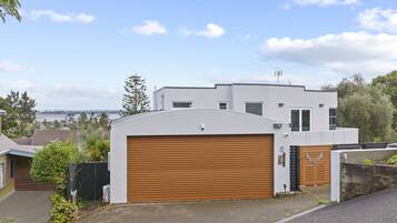 Situated in a residential area, this home offers a view of a body of water and distant hills.