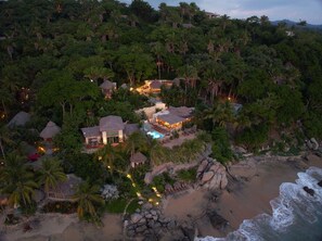 A resort with multiple buildings surrounded by dense tropical vegetation and a beach. - La Joya Sayulita (Sayulita)