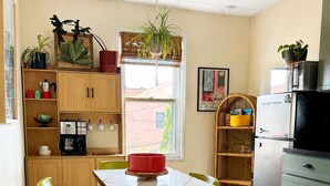 A kitchen with a dining table, chairs, a refrigerator, and various kitchen appliances. - Private 2nd story apartment in the heart of Long Beach- Pura Vida! (Long Beach)