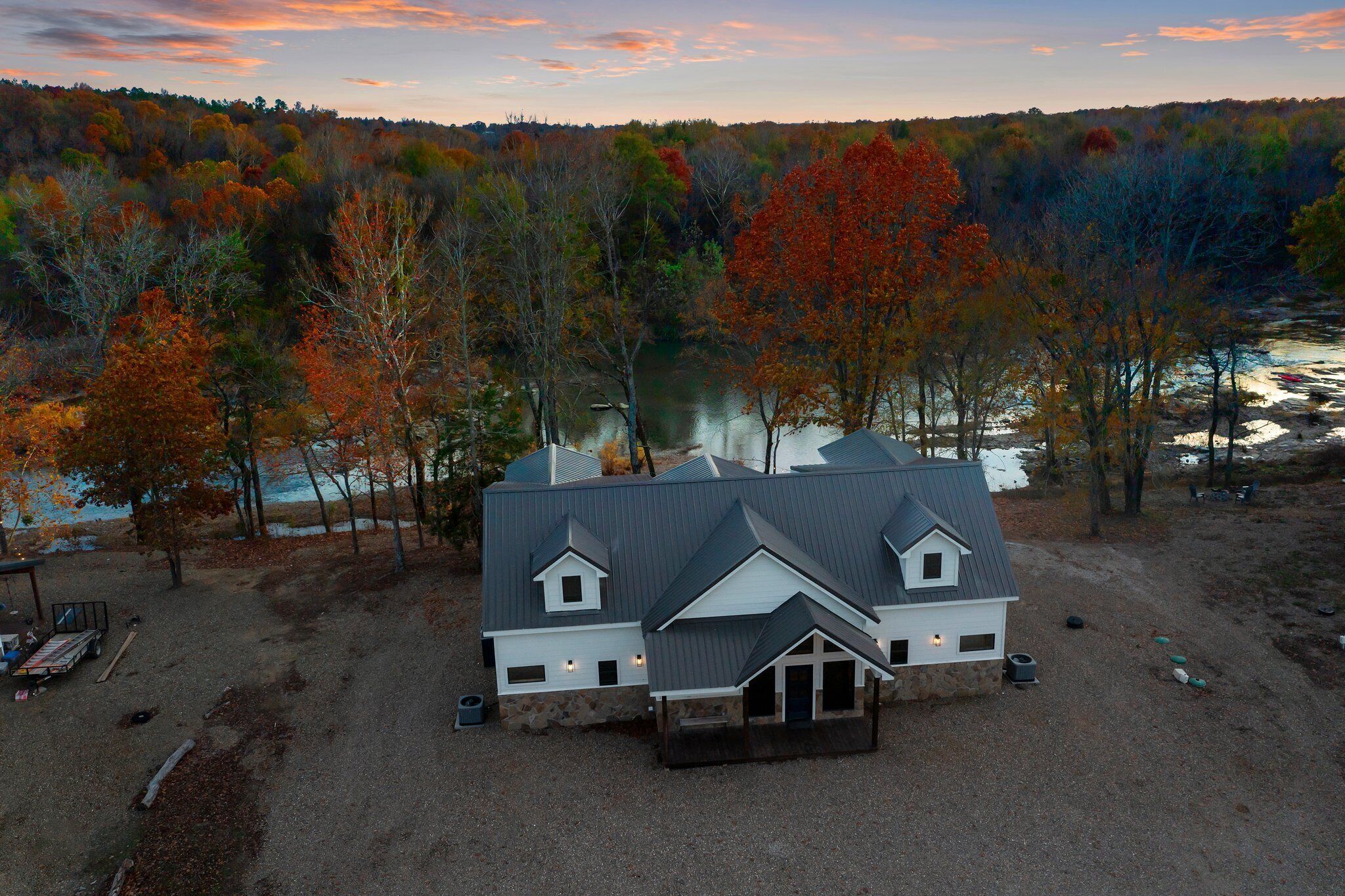 A two-story house with a gabled roof, a front porch, and a small attached garage.