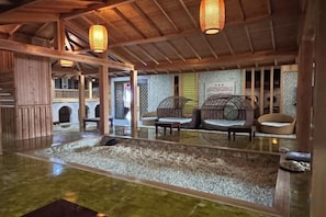 A traditional Japanese-style interior with tatami flooring, low wooden beams, and a seating area with cushions. - Xiyue wanda Hotel (Xiuyan)