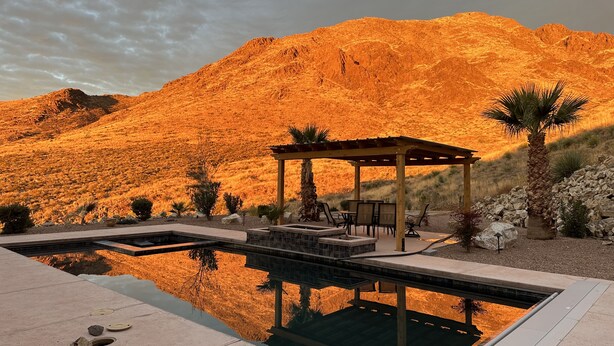 A pool area with a pergola, seating, and a mountain backdrop. - 60-acre custom home with breathtaking views of city of Las Cruces & Organs! (Las Cruces)