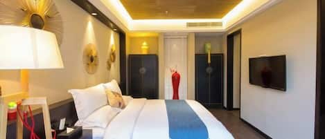 A modern hotel room with a large bed, bedside tables, a TV, and a unique ceiling design.