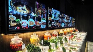 A buffet with various food items and a large digital menu display. - Riverside Garden Hotel (Taicang)