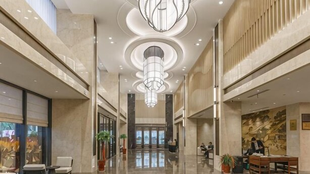 A spacious lobby with a high ceiling, large chandeliers, and a polished floor. - Riverside Garden Hotel (Taicang)