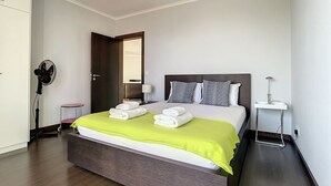 A modern hotel room with a large bed, a bedside table, a lamp, and a mirror. - Sunny Side by Atlantic Holiday (Madalena do Mar)