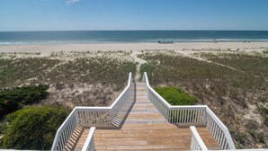 A wooden boardwalk leading to a beach with a clear view of the ocean. - Luxury Beachfront Duplex w/ Hot Tubs, Private Access & Susnset Views (Holden Beach)