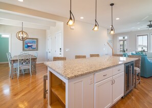 Enjoy meals in the kitchen with a central island and dining area, perfect for socializing.