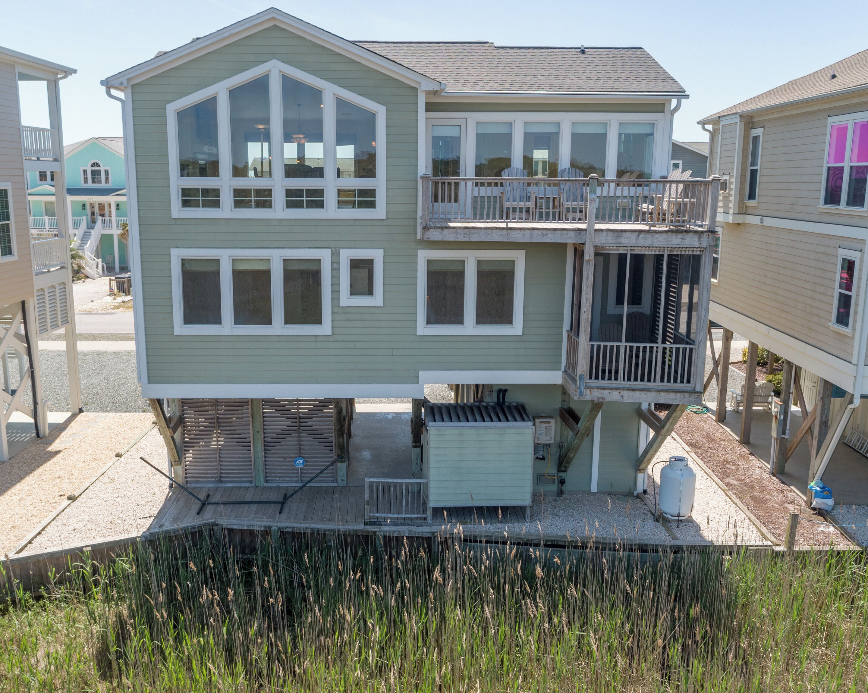 A two-story house with a balcony and a covered outdoor area.