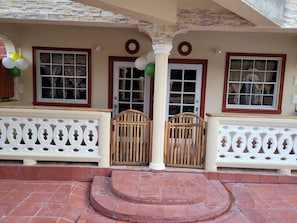 Stunning building facade with numbered entry doors and decorative railing.