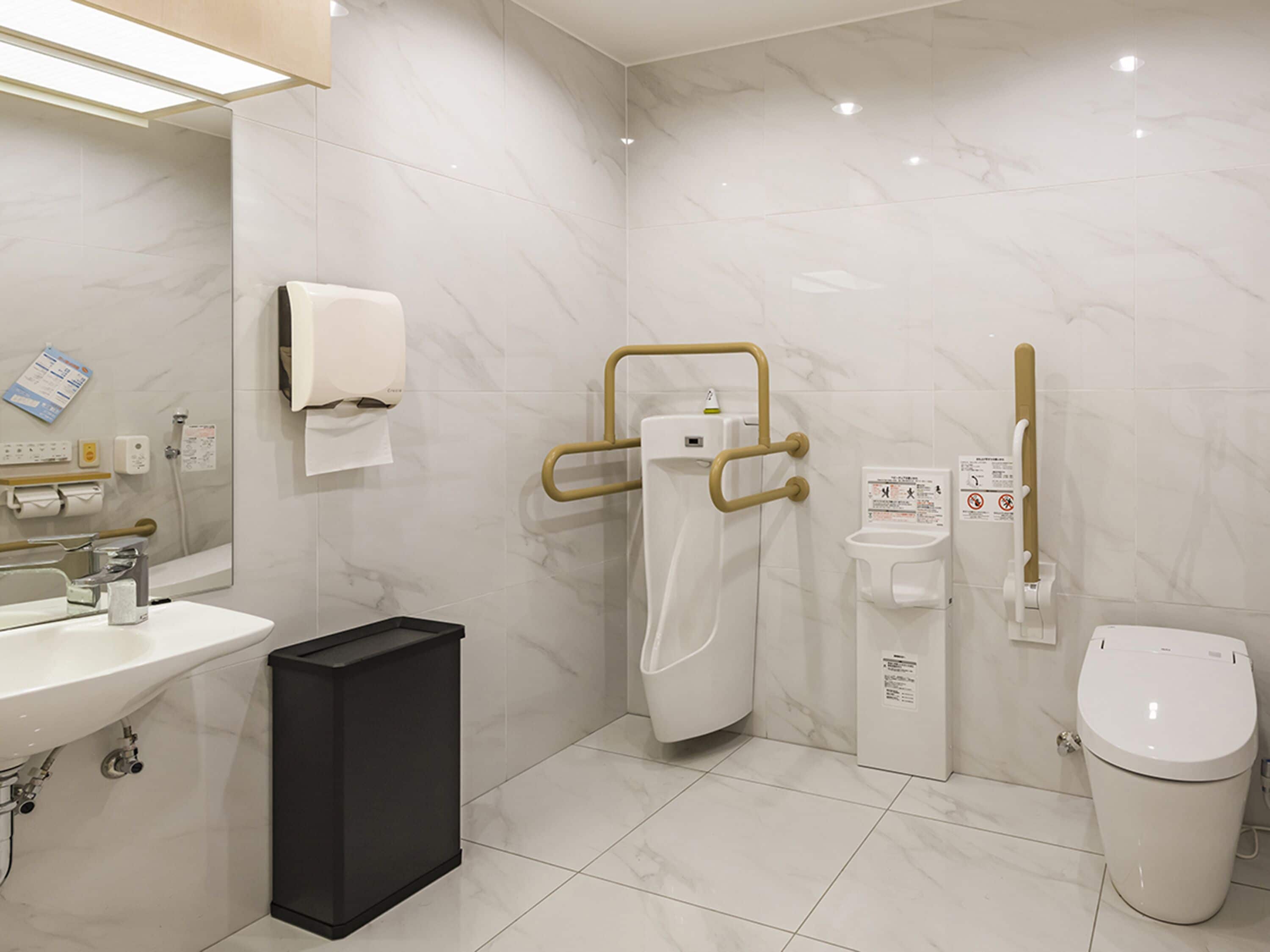 A modern bathroom with a sink, toilet, and shower area.