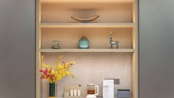 A shelf with decorative items, a vase with flowers, and a coffee maker.