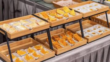 Een buffet met verschillende soorten eten, gerangschikt op houten schalen.