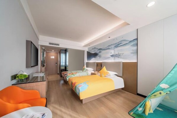 A hotel room with a bed, two bedside tables, a desk, and a chair.