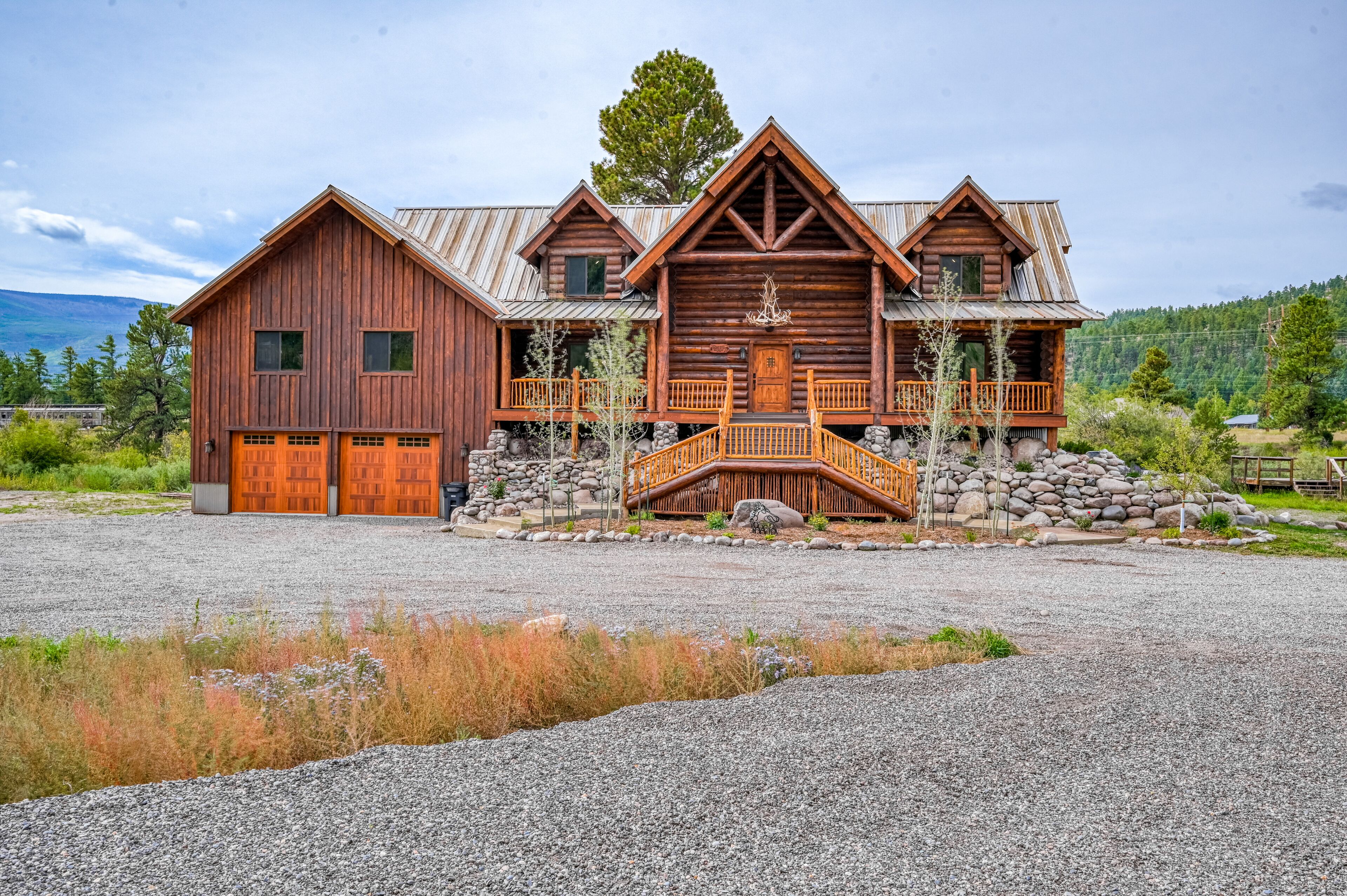 Custom riverfront log home w/ hot tub, decks & fireplace