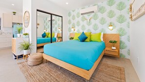 A modern bedroom with a large bed, bedside tables, and a mirror. - New Listing Discount! Fire Pit~Hammocks (Joshua Tree)