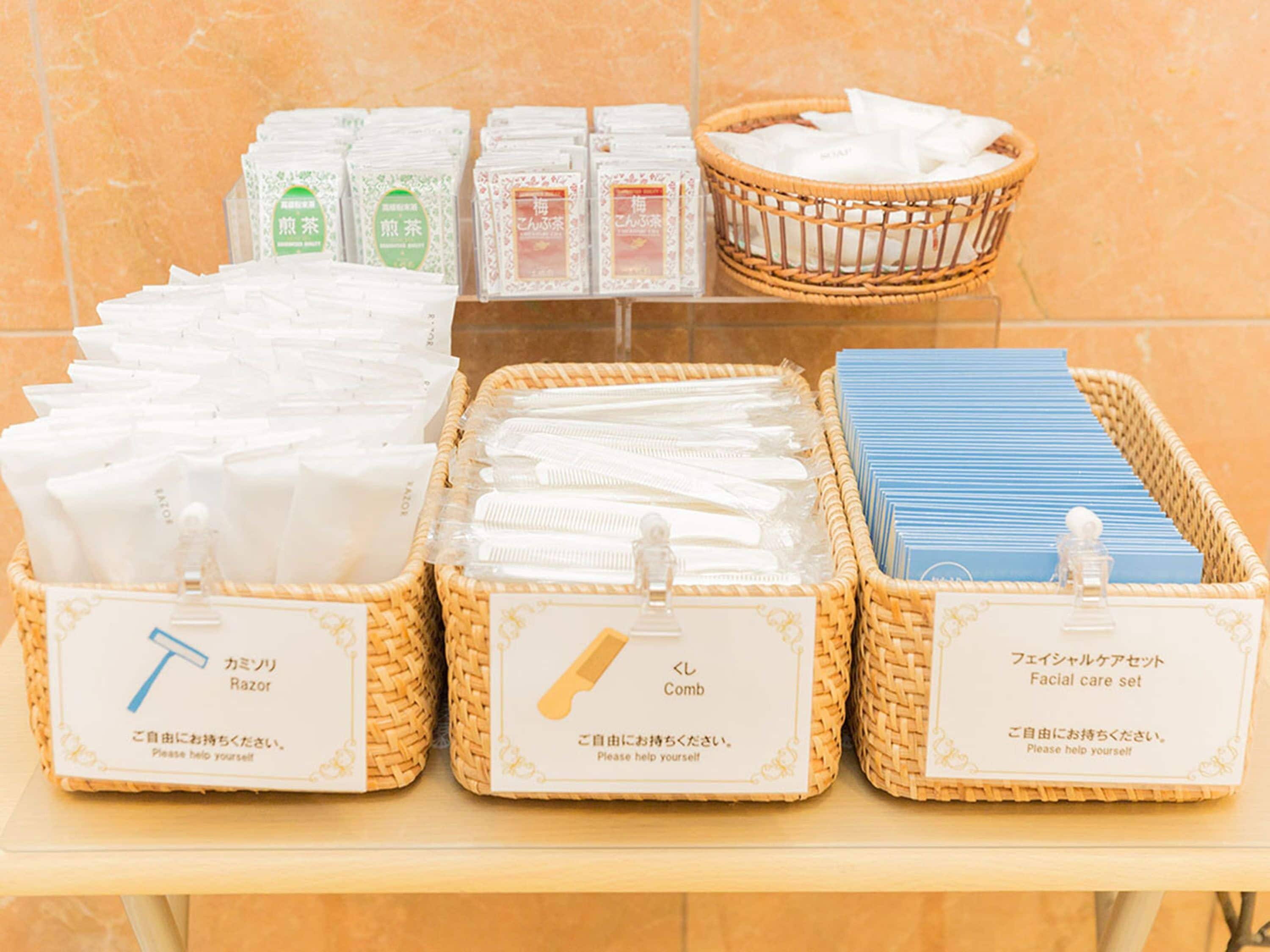 A display of personal care items including razors, combs, and facial care sets in wicker baskets.