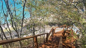 A wooden staircase leading to a beach with a view of the ocean. - Sunset Serenity - INCREDIBLE HOME ON BLUFF OVERLOOKING LAKE MICHIGAN! (Frankfort)