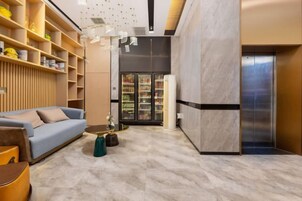 A modern interior with a sofa, coffee table, and shelves.