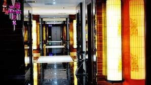 A hotel corridor with a reflective floor, wooden paneling, and traditional lanterns. - Longfengxiang Hotel (Dongying)