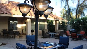 An outdoor patio area with seating, a fire pit, and a pergola with lights. - New Fresh Water Single Level home 2.3 miles to Mayo Clinic, Kierland, WestWorld (Scottsdale)