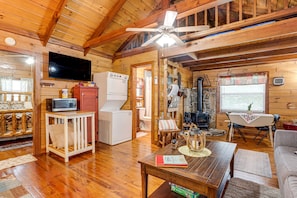 Relax in a cozy cabin with a living area, flat-screen TV, and compact kitchenette.