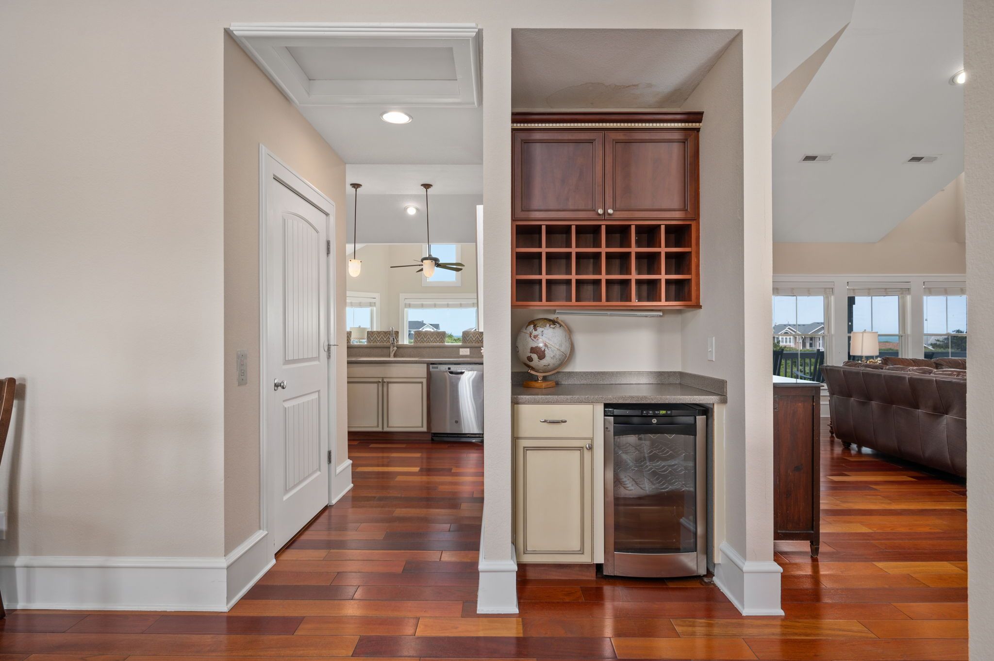 A modern kitchen with wooden cabinets, a dishwasher, and a built-in oven.