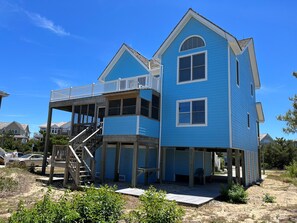 A two-story house with a balcony and a covered porch.