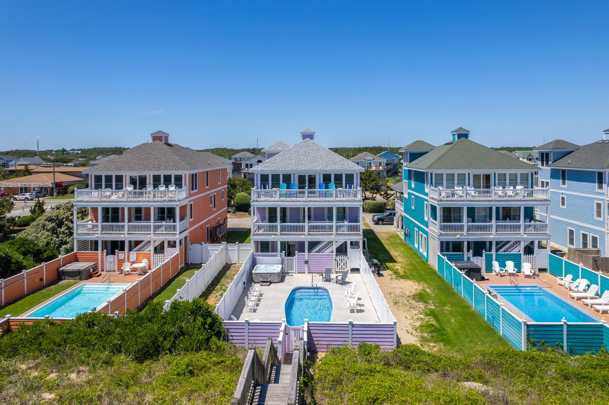 A resort with multiple buildings, outdoor pools, and a clear view of the surrounding area.