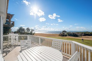 A balcony with a view of a beach and golf course.