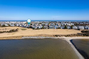 A coastal residential area with houses, a beach, and a body of water. - Sound View: Soundfront, water, golf course & great sunset views, community pool! (Nags Head)