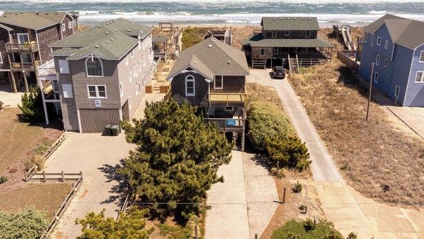 A coastal residential area with houses, a beach, and a clear view of the ocean. - Sea Rest: Oceanfront, private walkway to beach, hot tub, YMCA access. (Nags Head)