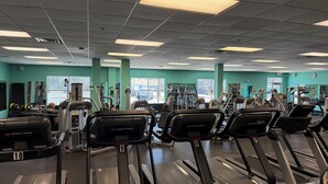 A gym with treadmills, weight machines, and exercise equipment. - Sea Rest: Oceanfront, private walkway to beach, hot tub, YMCA access. (Nags Head)