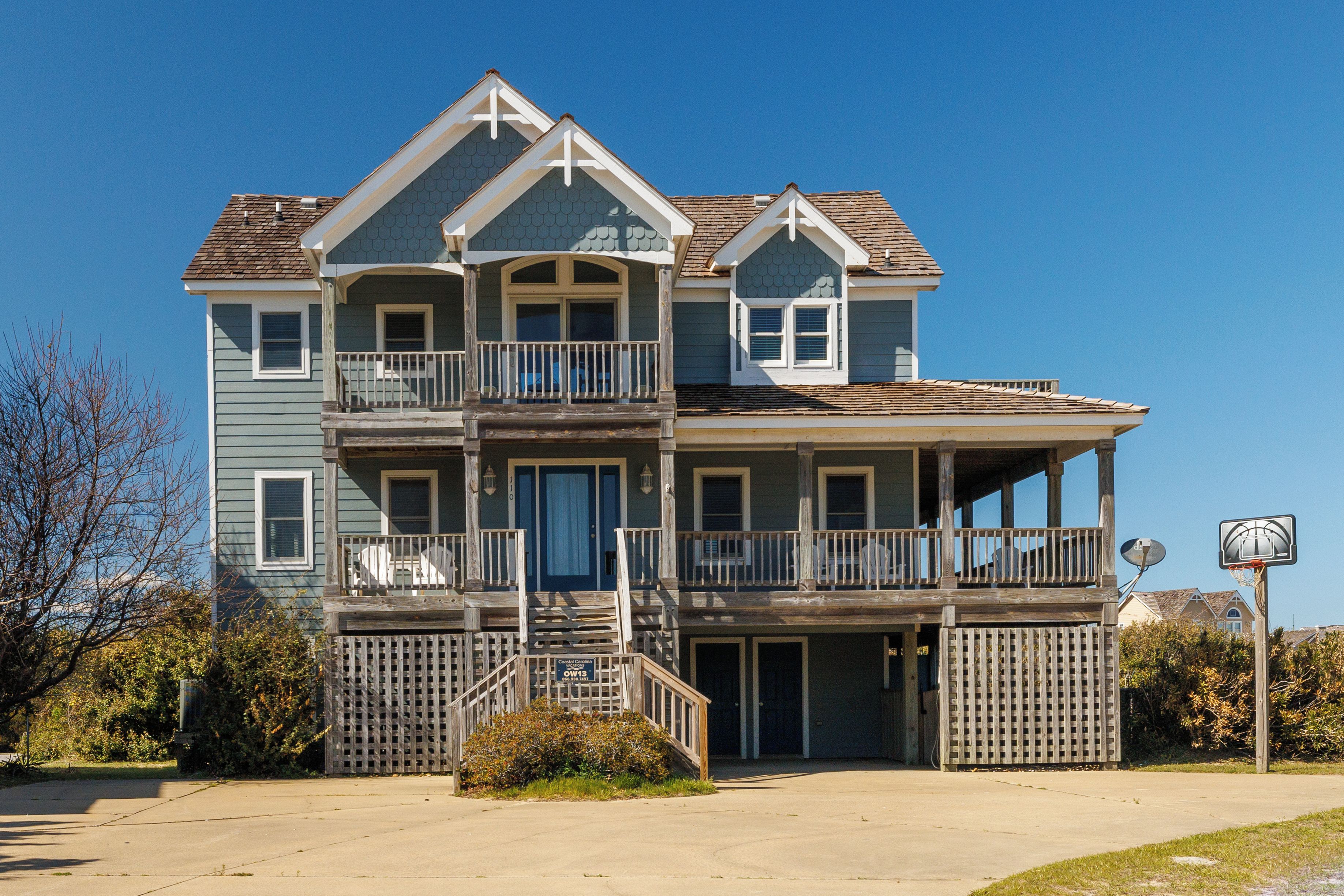 A two-story building with a balcony, a front door, and a satellite dish.