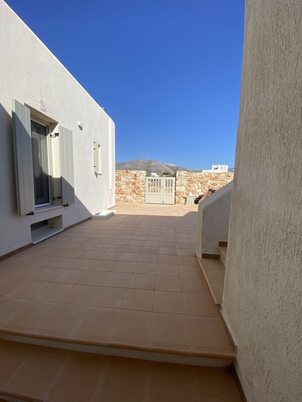 Stroll through this serene corridor to a courtyard with breathtaking mountain views.