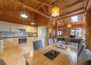 A wooden interior with a kitchen, dining area, and living space.