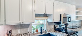 Retro-chic retreat near the beach with a fenced yard & deck, & washer/dryer