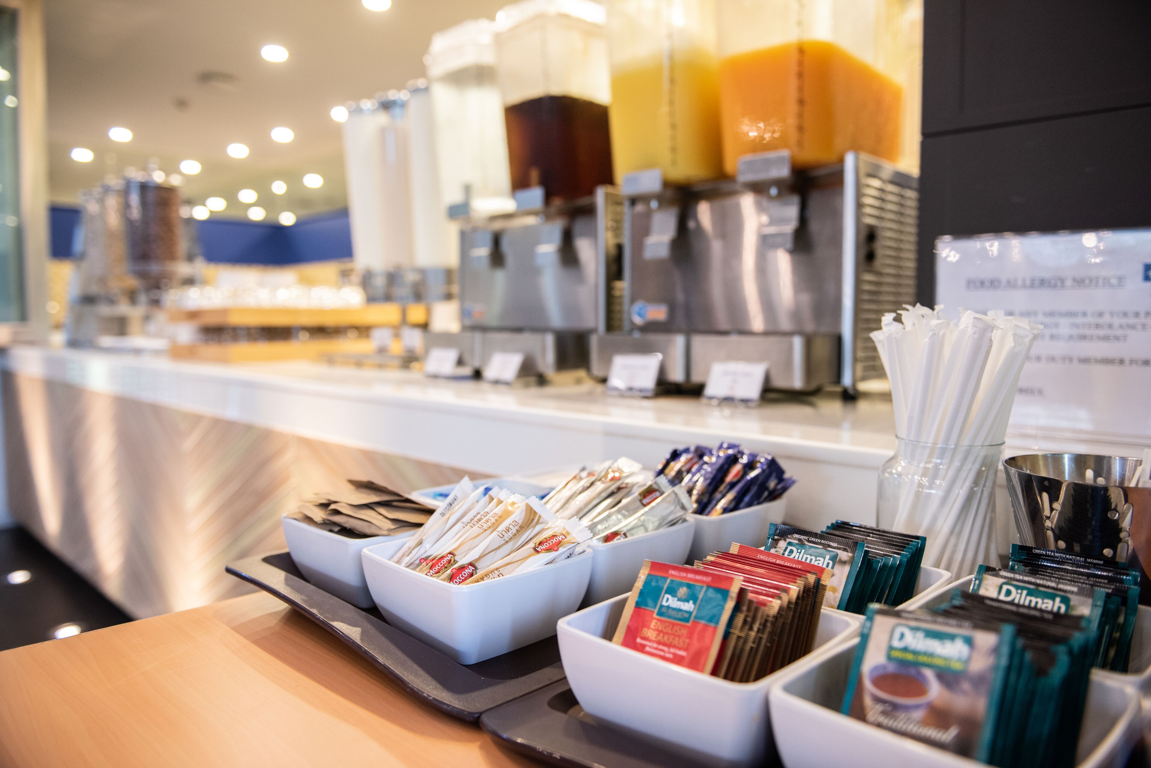 A coffee station with various coffee pods and a coffee machine in the background.