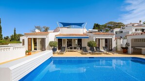 A swimming pool with sun loungers and a covered patio area. - Casa Sonny - villa with airco and pool near golf course, beaches and town (Carvoeiro)